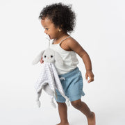 Toddler using the BooginHead Plush PaciPal Teether Blanket, Floppy the Bunny. Keeps track of pacifier with attaching loop. Super soft fabric from a woman owned small business. Essential baby gear!