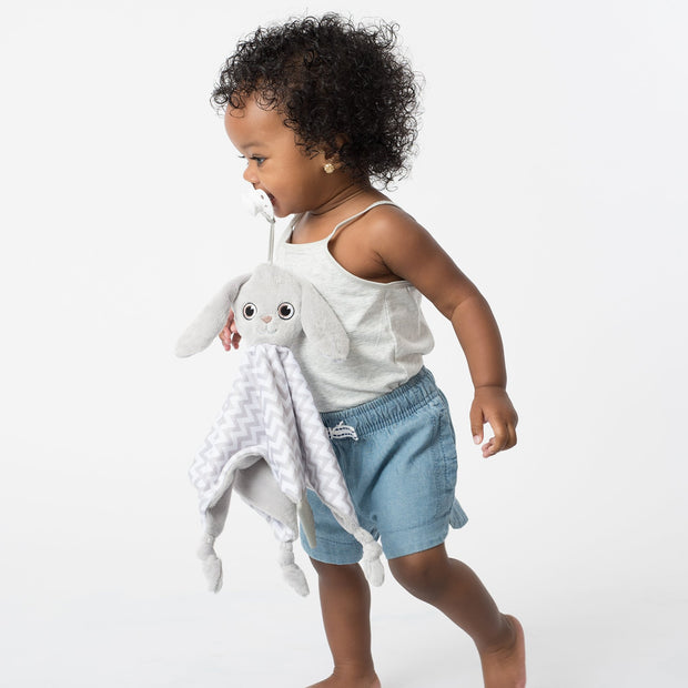 Toddler using the BooginHead Plush PaciPal Teether Blanket, Floppy the Bunny. Keeps track of pacifier with attaching loop. Super soft fabric from a woman owned small business. Essential baby gear!