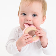 Baby using BooginHead Silicone & wood teething rings, pink bunny