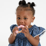 Baby using BooginHead silicone & wood teething rings, pink bunny