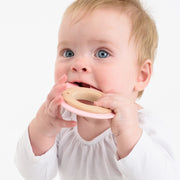 Baby using BooginHead silicone & wood teething rings, pink bunny