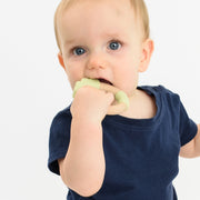 Baby using BooginHead silicone & wood teething rings, green lion