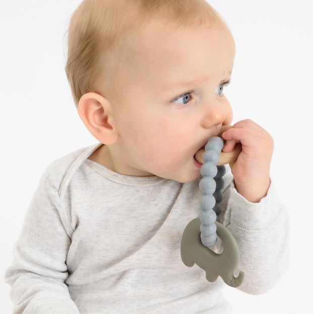 Baby using BooginHead silicone & wood teether, gray elephant